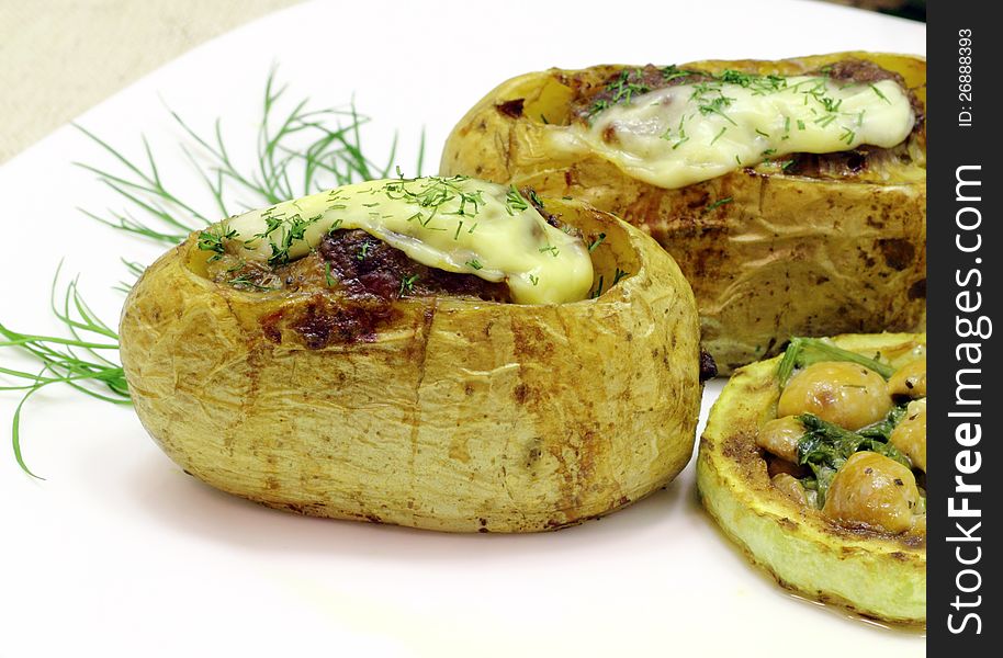 Stuffed potatoes with stewed mushroom sauce and grilled zucchini
