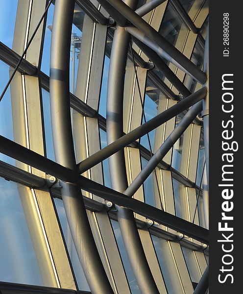 Steel beams and rods in a curved structure forms a glass facade. Steel beams and rods in a curved structure forms a glass facade