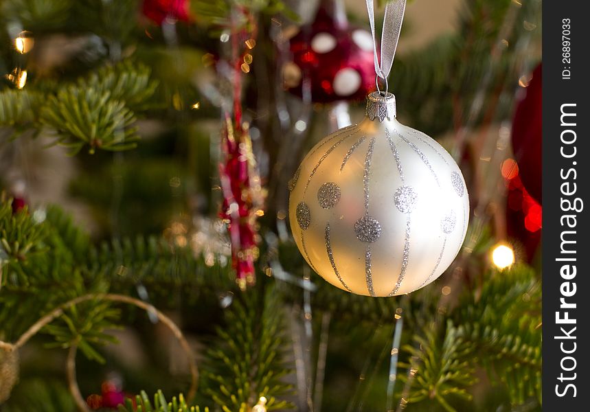 Christmas ball on green tree close up