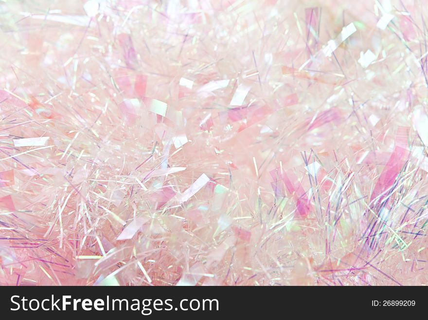 Pastel pink tinsel background, suitable for Christmas.