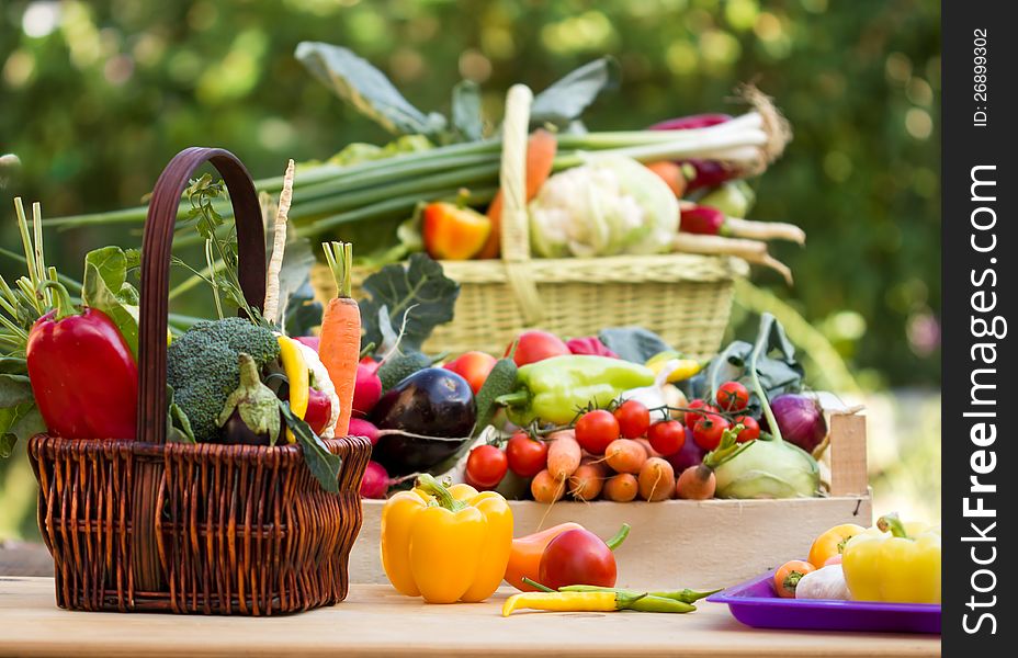 Various vegetables in a wicker baskets, crates and on the table. Various vegetables in a wicker baskets, crates and on the table