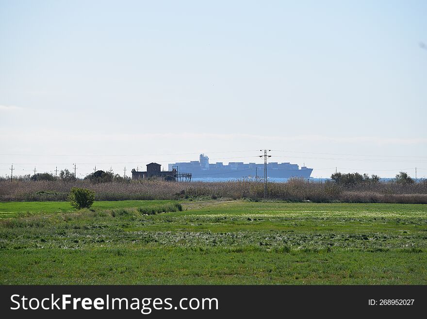 Container Ship Sailing Along The Coast.