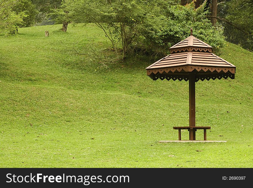 A wooden umbrella hut at park. A wooden umbrella hut at park