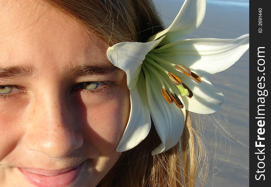 Young girl on the beach with a flower in her hair. Young girl on the beach with a flower in her hair