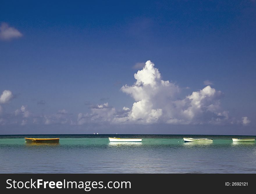 Row of fisherman;s boats at anchor along Cote D'Or beach, Praslin,Sechelles. Row of fisherman;s boats at anchor along Cote D'Or beach, Praslin,Sechelles