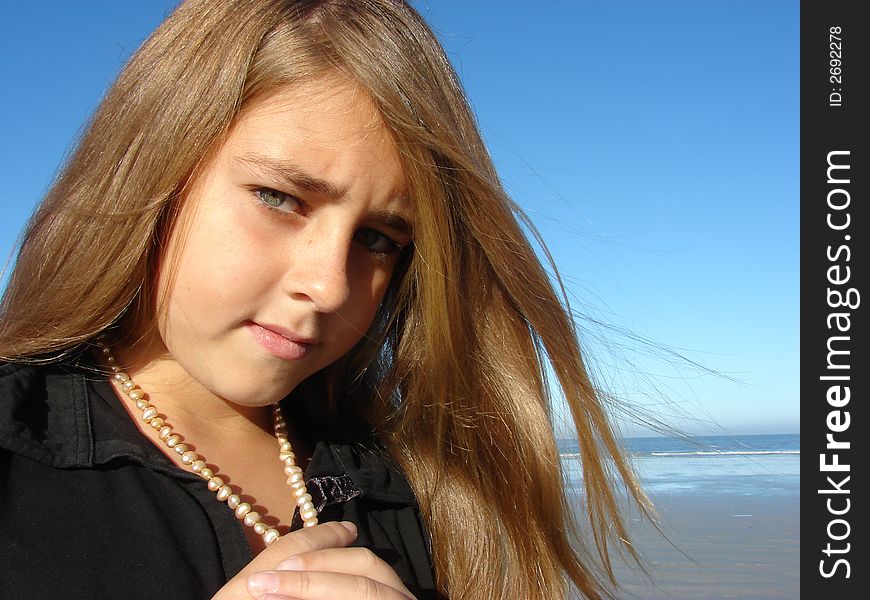 Beautiful young girl on the beach with pearls. Beautiful young girl on the beach with pearls