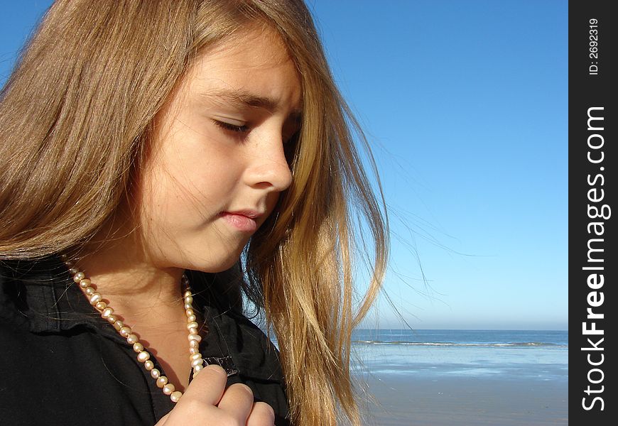 Young girl on the beach, Head & Shoulders shot with jewellery. Young girl on the beach, Head & Shoulders shot with jewellery