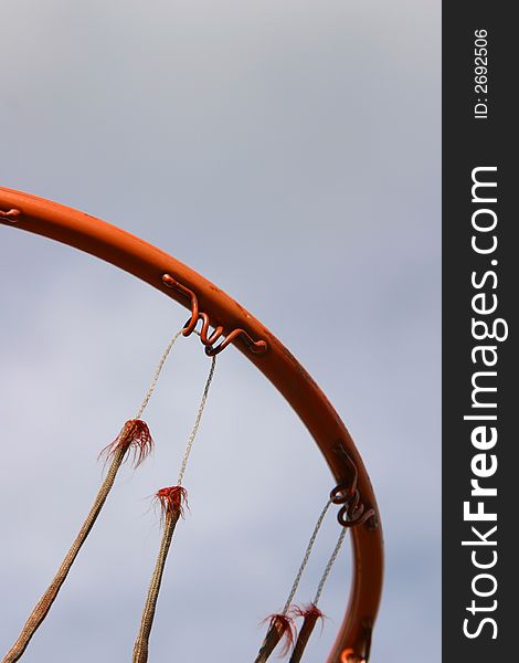 A ring from a basketball hoop with an old and torn net. A ring from a basketball hoop with an old and torn net.