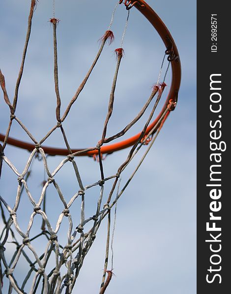 Basketball equipment - a hoop with a really old net.