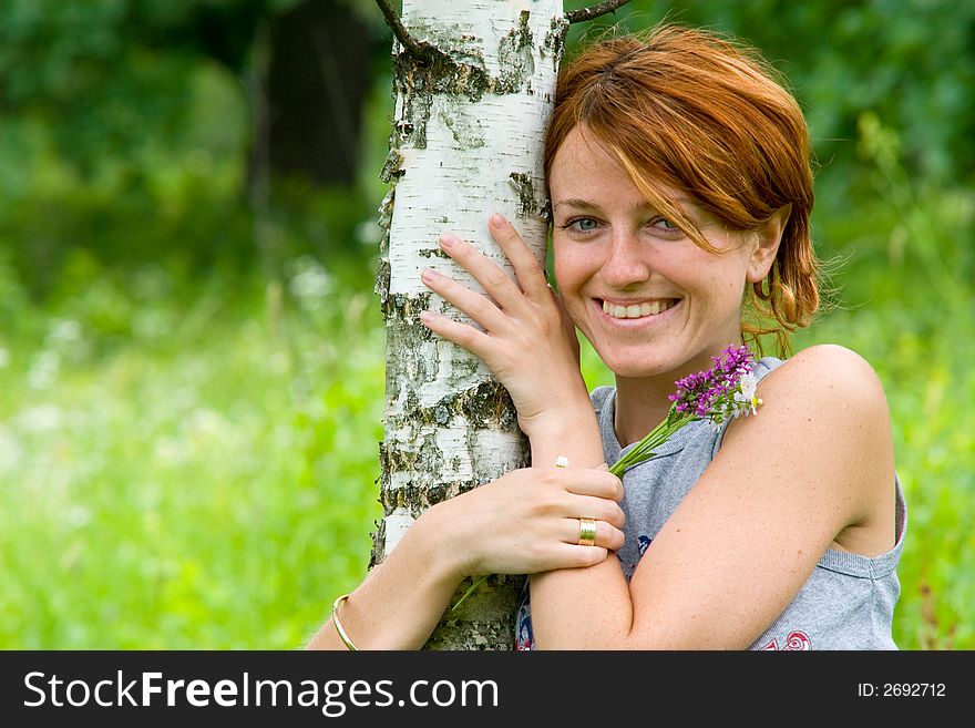 Outdoor shot, smiling girl embrace a birch tree on the summer meadow. Outdoor shot, smiling girl embrace a birch tree on the summer meadow
