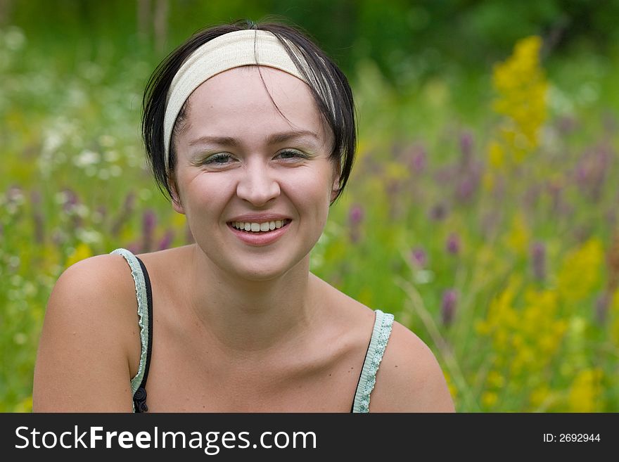 Smiling girl on meadow worn beige frontlet