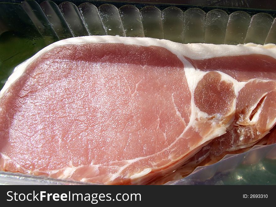 An image of some sliced bacon within its package.