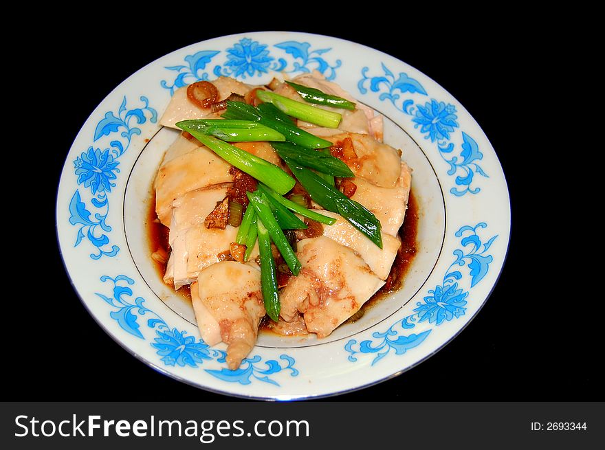 A plate of white cut chicken ready to be served. A plate of white cut chicken ready to be served