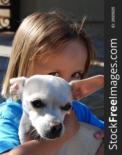 Little boys eyes peeking up from above his little dog. Little boys eyes peeking up from above his little dog