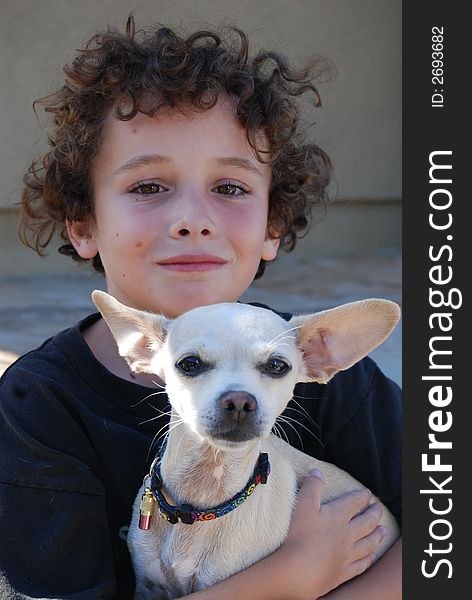 boy holding a little chiwawa dog