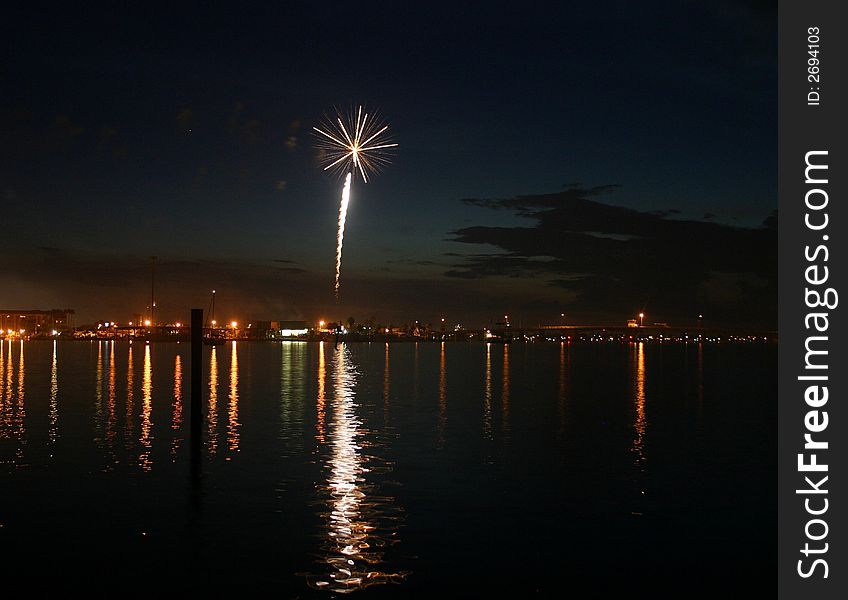 Fireworks shot off over ocean.