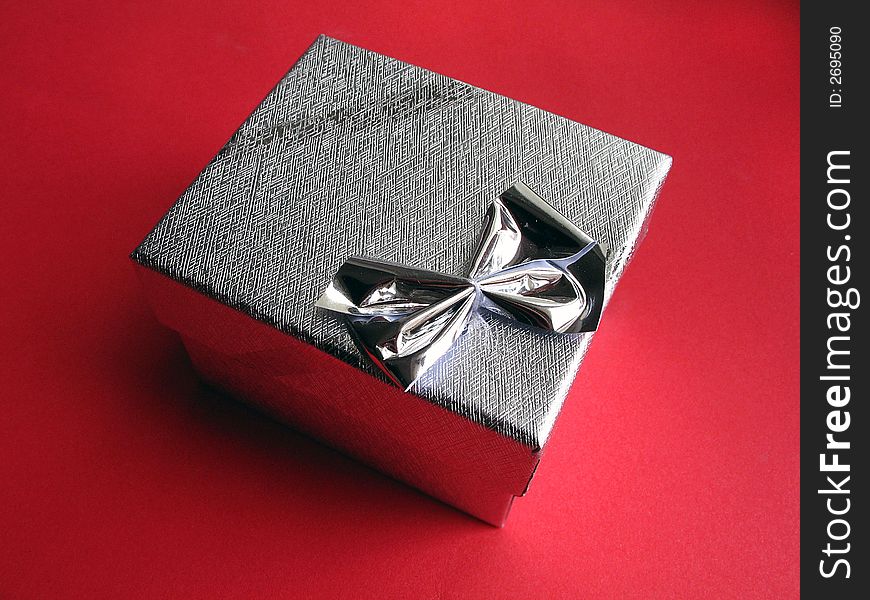 Small box with knot on red background. Small box with knot on red background