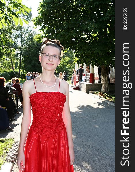 Young graduate on school yard.