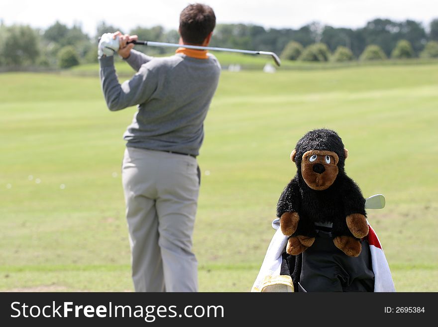 Man golf swing with monkey