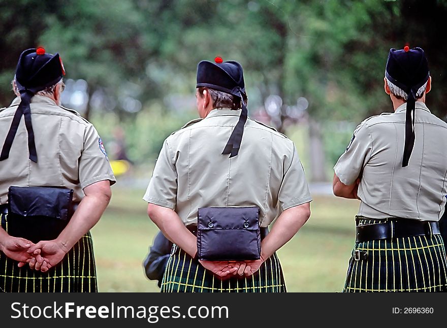 Three men wearing kilts, observing scottish festival