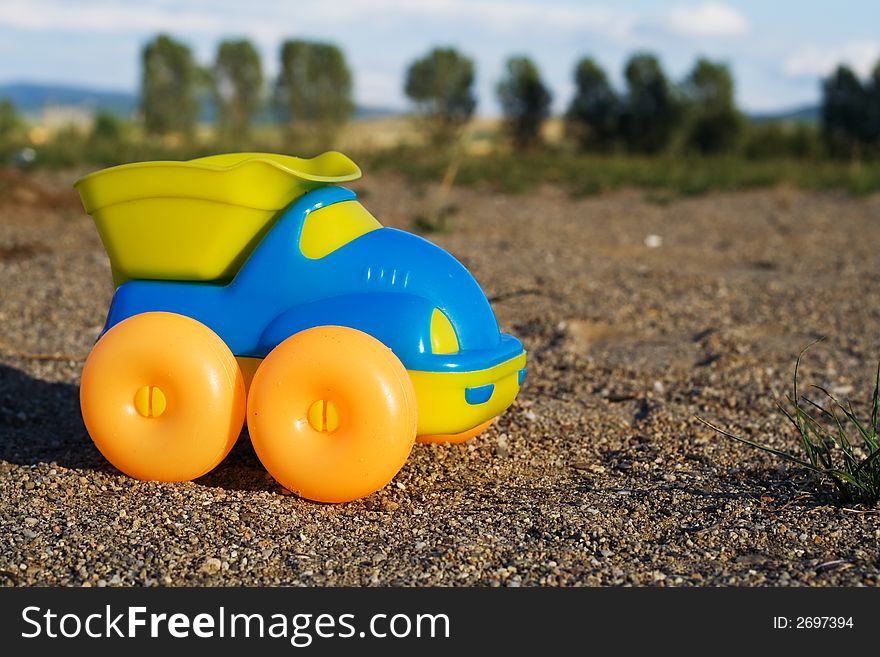 Toy car on a deserted playground at dusk - the perspective creates a reality-like, authentic feeling