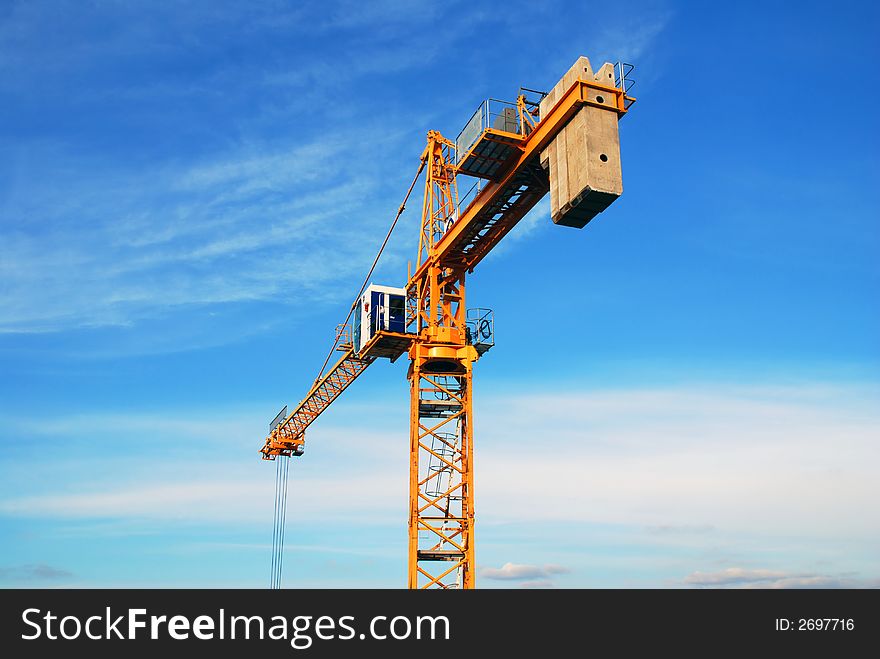 Tower crane before the sky background