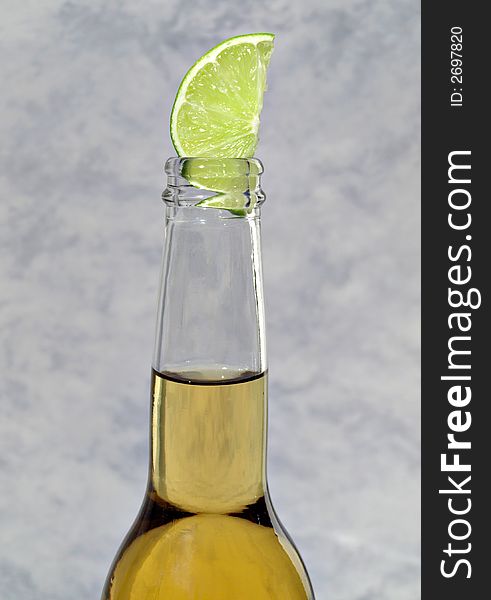 A bottle of beer with a lime in it. A bottle of beer with a lime in it