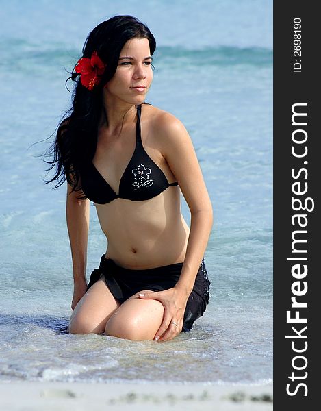 Young tropical girl portrait wearing bikini on beach background. Young tropical girl portrait wearing bikini on beach background