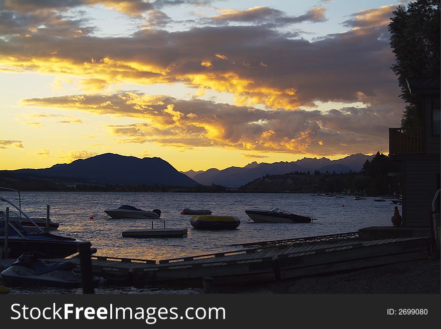 Evening clouds over boats moored on Windermere Lake, British Columbia, during the summer. Evening clouds over boats moored on Windermere Lake, British Columbia, during the summer.