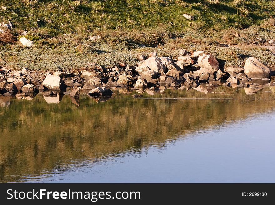 Reflection Of Rocks In Water