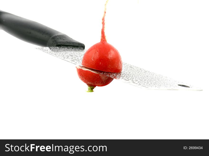 Radish cut with cleaver on a white background