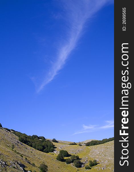 An isolated wake cloud in the blue sky. An isolated wake cloud in the blue sky.