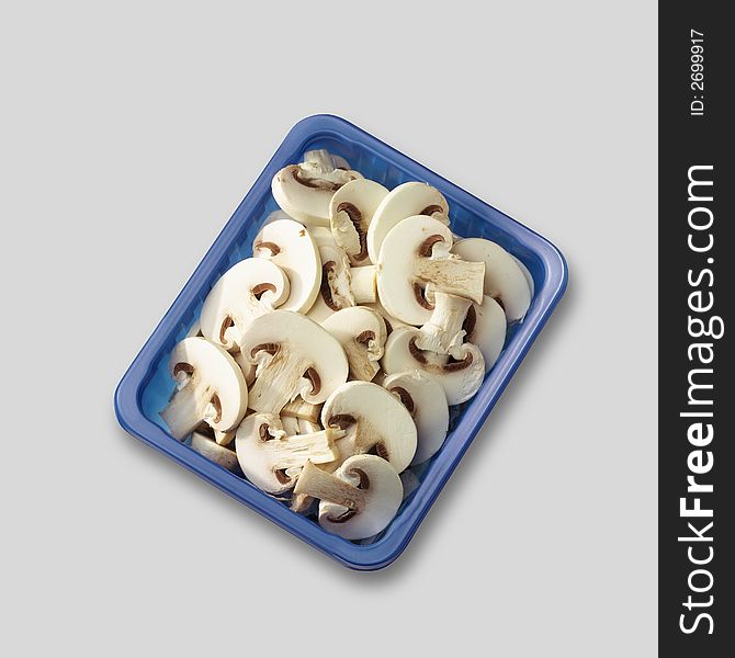 Sliced champignon in blue container. Sliced champignon in blue container