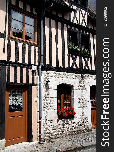 Timber Framed Village House in Normandy, France with pretty flower filled window boxes. Timber Framed Village House in Normandy, France with pretty flower filled window boxes