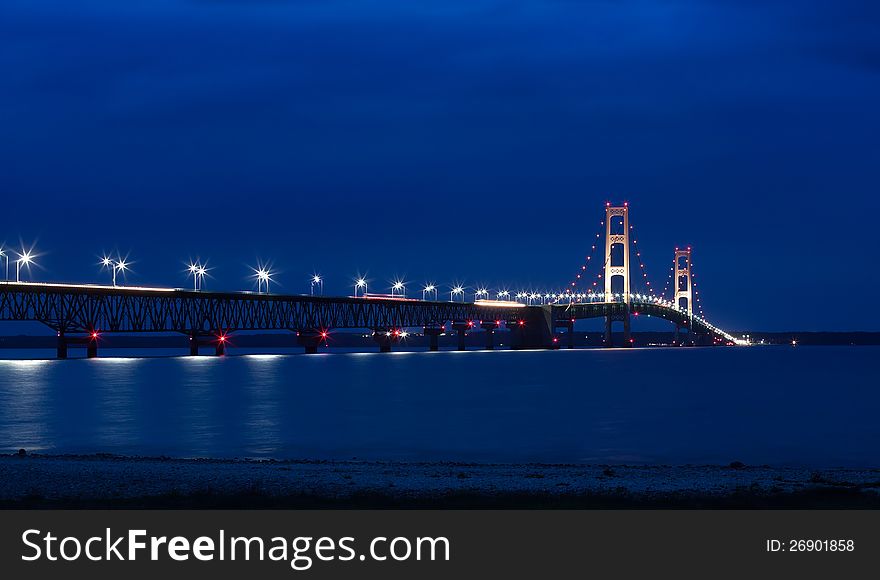 The Mackinac Bridge is located on Interstate 75 in northern Michigan at the Straits of Mackinac. The bridge connects Michigan's upper and lower peninsulas. The Mackinac Bridge is located on Interstate 75 in northern Michigan at the Straits of Mackinac. The bridge connects Michigan's upper and lower peninsulas.