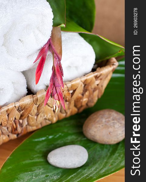 SPA. Tropical flower on a towel and stones