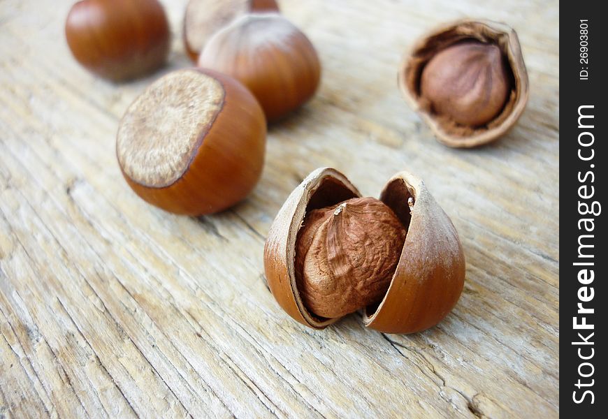 Hazelnuts on a wooden background