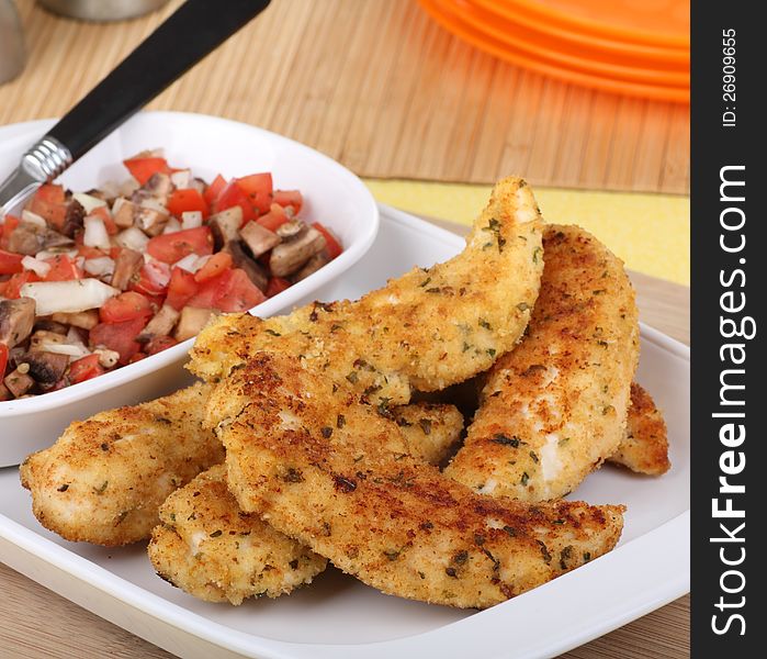 Meal of chicken tenderloin strips on a serving platter