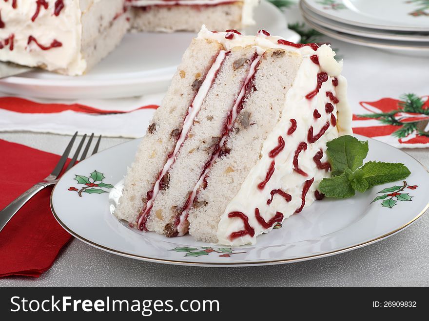 Piece of white cake on a Christmas plate. Piece of white cake on a Christmas plate