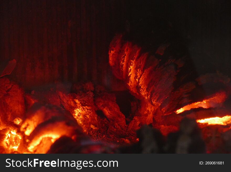 embers burning wood in a domestic fireplace