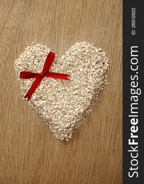 Heart shape oatmeal on wooden background. Good for healty food concept