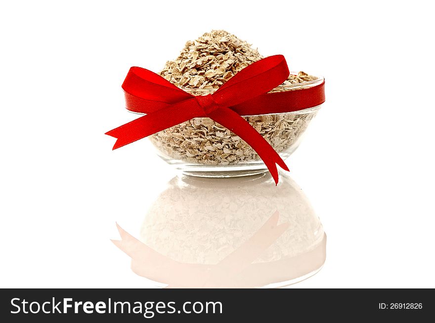 Oatmeal in glass bowl  over white background