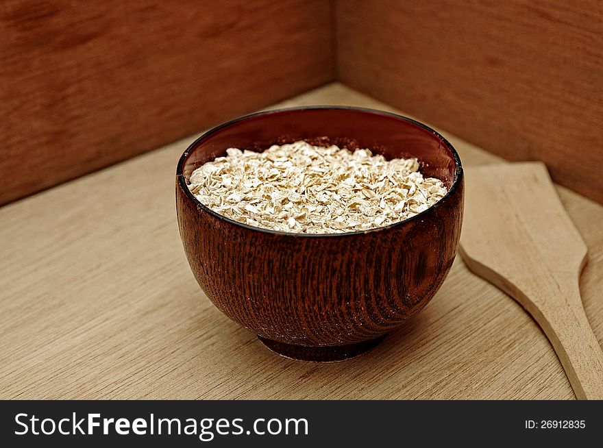 Oatmeal in the wooden bowl. This is healthy food concept. Oatmeal in the wooden bowl. This is healthy food concept