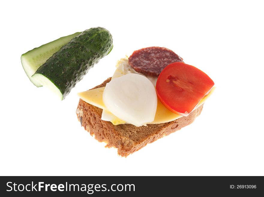 Bread with sausage, cheese and vegetables. Isolated on a white background. Bread with sausage, cheese and vegetables. Isolated on a white background.