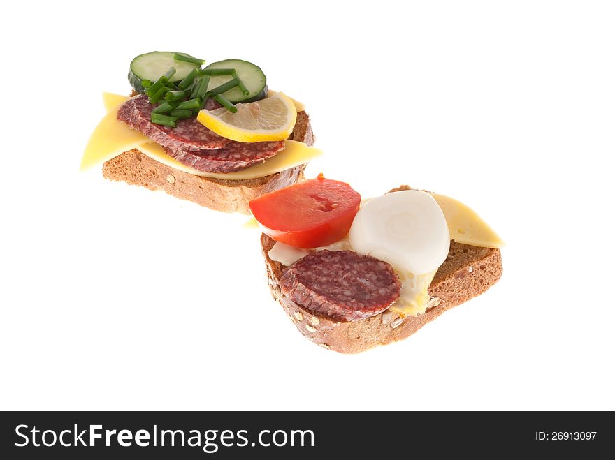 Bread with sausage, cheese, egg and vegetables. Isolated on a white background. Bread with sausage, cheese, egg and vegetables. Isolated on a white background.