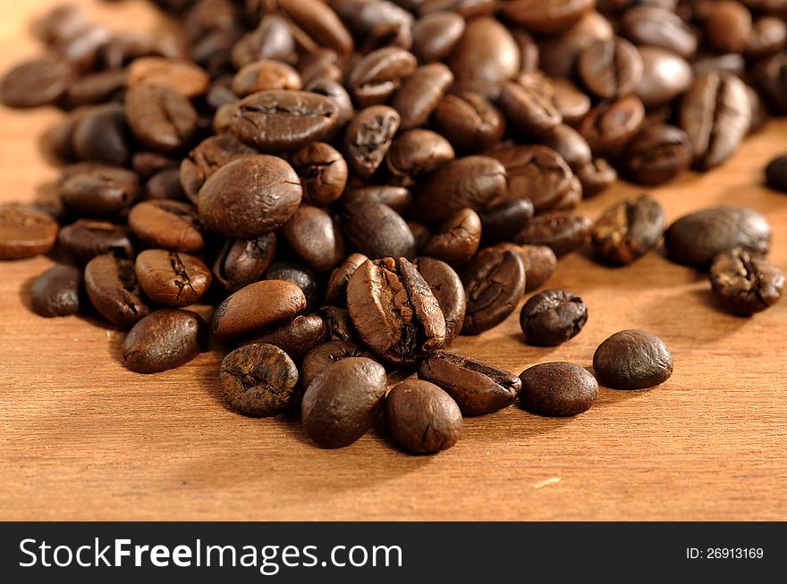 Coffee beans shot on the wooden background