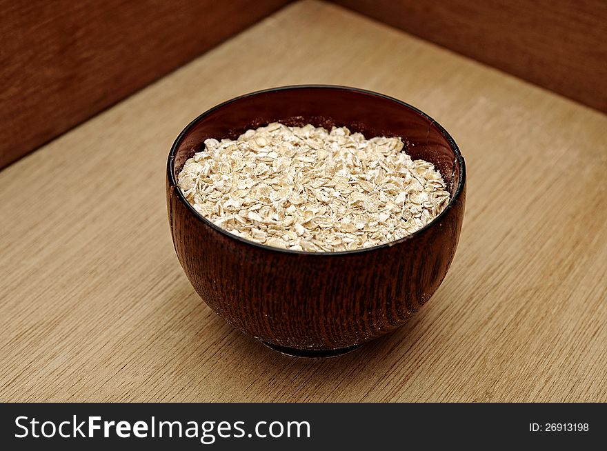 Oatmeal in the wooden bowl. This is healthy food concept. Oatmeal in the wooden bowl. This is healthy food concept