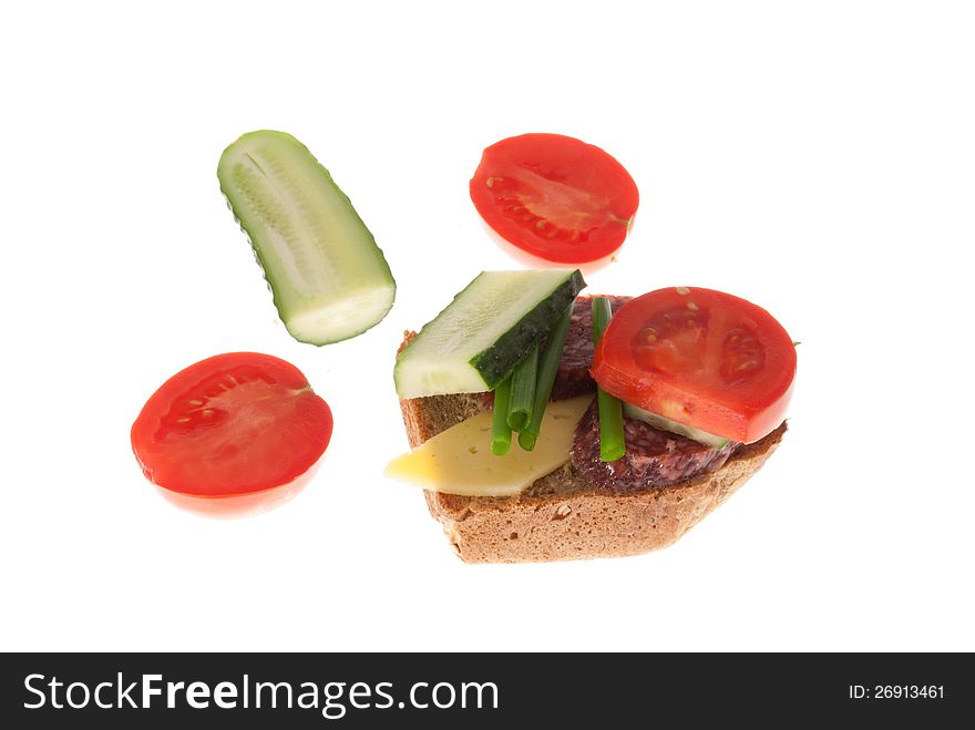 Bread with sausage, cheese and vegetables. Isolated on a white background. Bread with sausage, cheese and vegetables. Isolated on a white background.