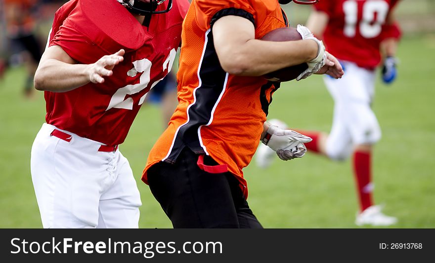 American football players fighting for the ball