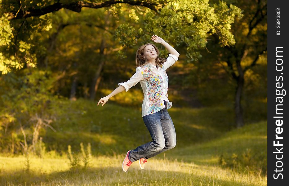 Young pretty woman jumping in the autumn park. Young pretty woman jumping in the autumn park